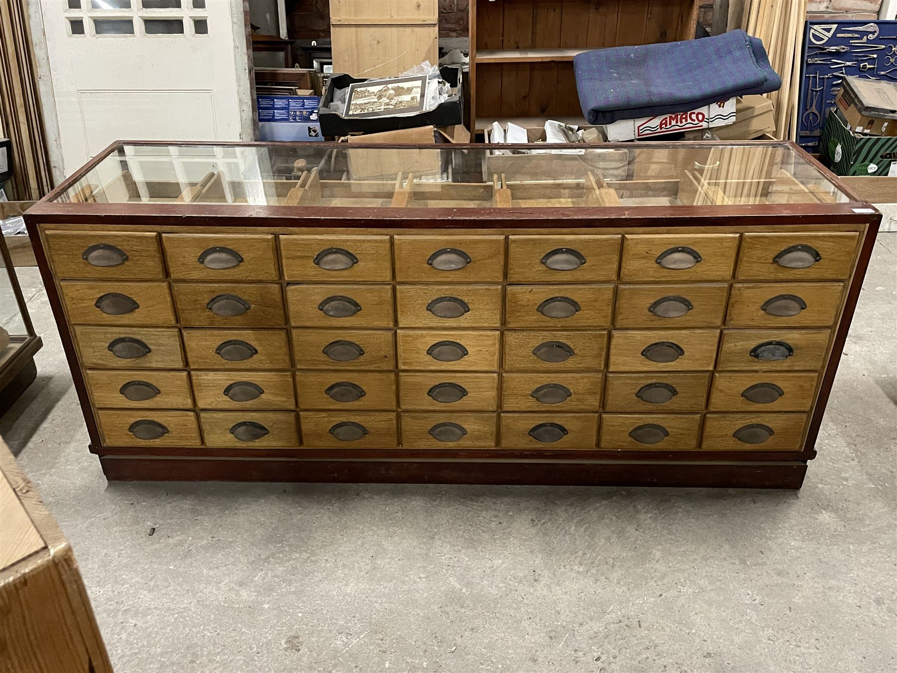 20th century mahogany and glazed haberdashery shop's display cabinet, fitted with thirty-five small drawers, on skirted base  - THIS LOT IS TO BE COLLECTED BY APPOINTMENT FROM THE OLD BUFFER DEPOT, MELBOURNE PLACE, SOWERBY, THIRSK, YO7 1QY