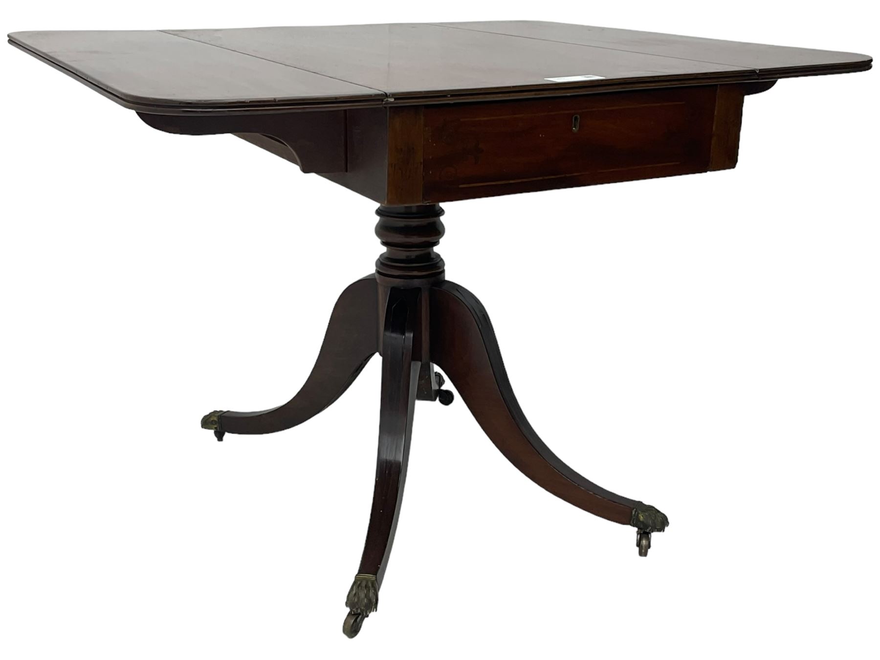 Early 19th century mahogany supper table, rectangular reed moulded drop-leaf top with rounded corners, fitted with single end drawer, on turned pedestal with four out-splayed supports with brass paw castors 