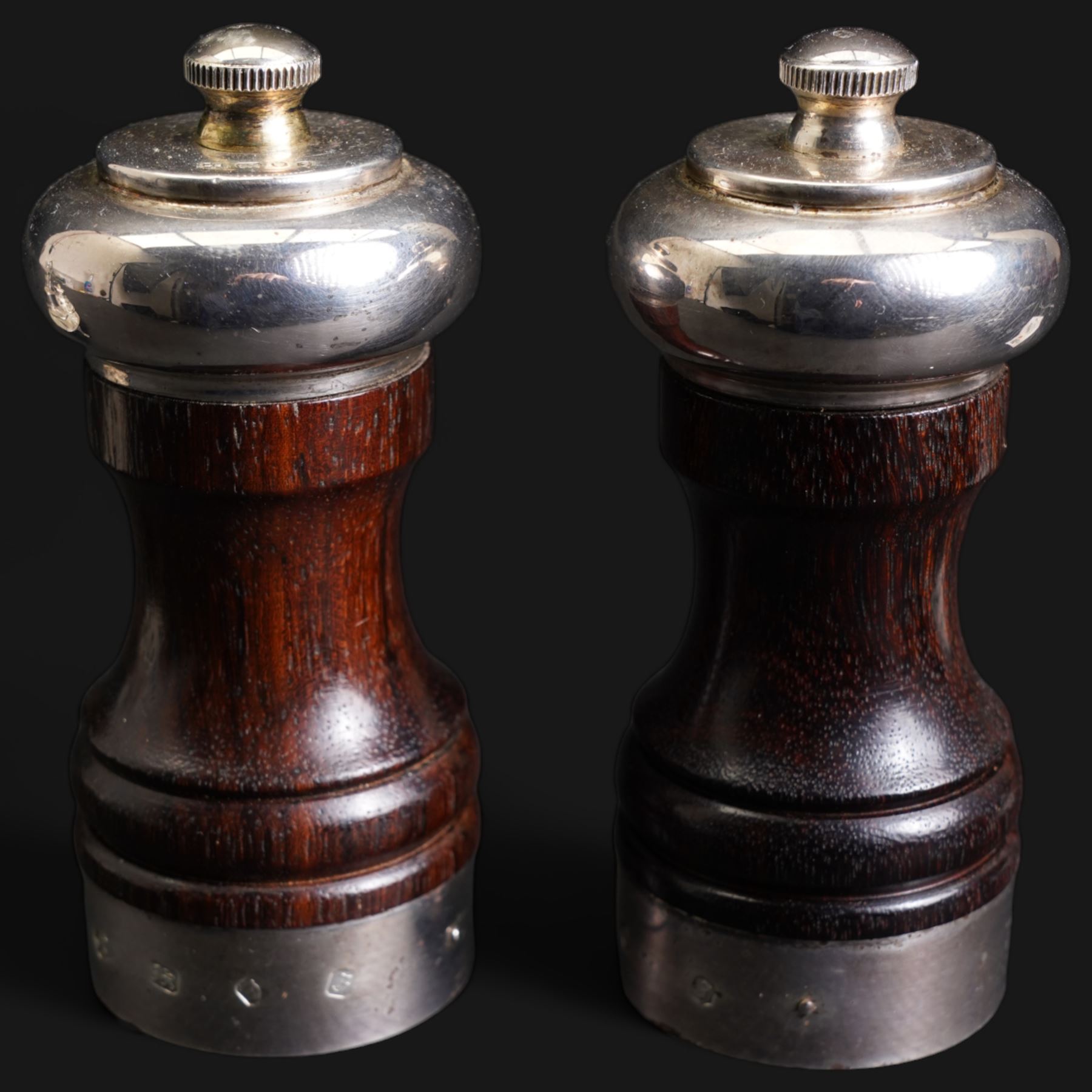 Edwardian small silver navette shape four division cruet fitted with glass and silver mounted bottles London 1902 Maker Hukin & Heath and a pair of mahogany silver banded pepper mills London 1980 Maker Davis Shaw Silverware 