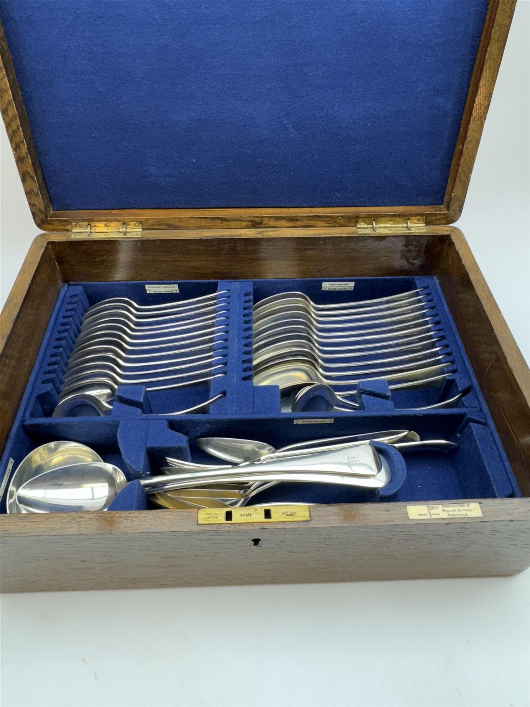 Walker & Hall canteen of plated cutlery for for twelve place settings, all knives with ivory effect handles, within an oak canteen case with a brass shield to the lid, with key, case  