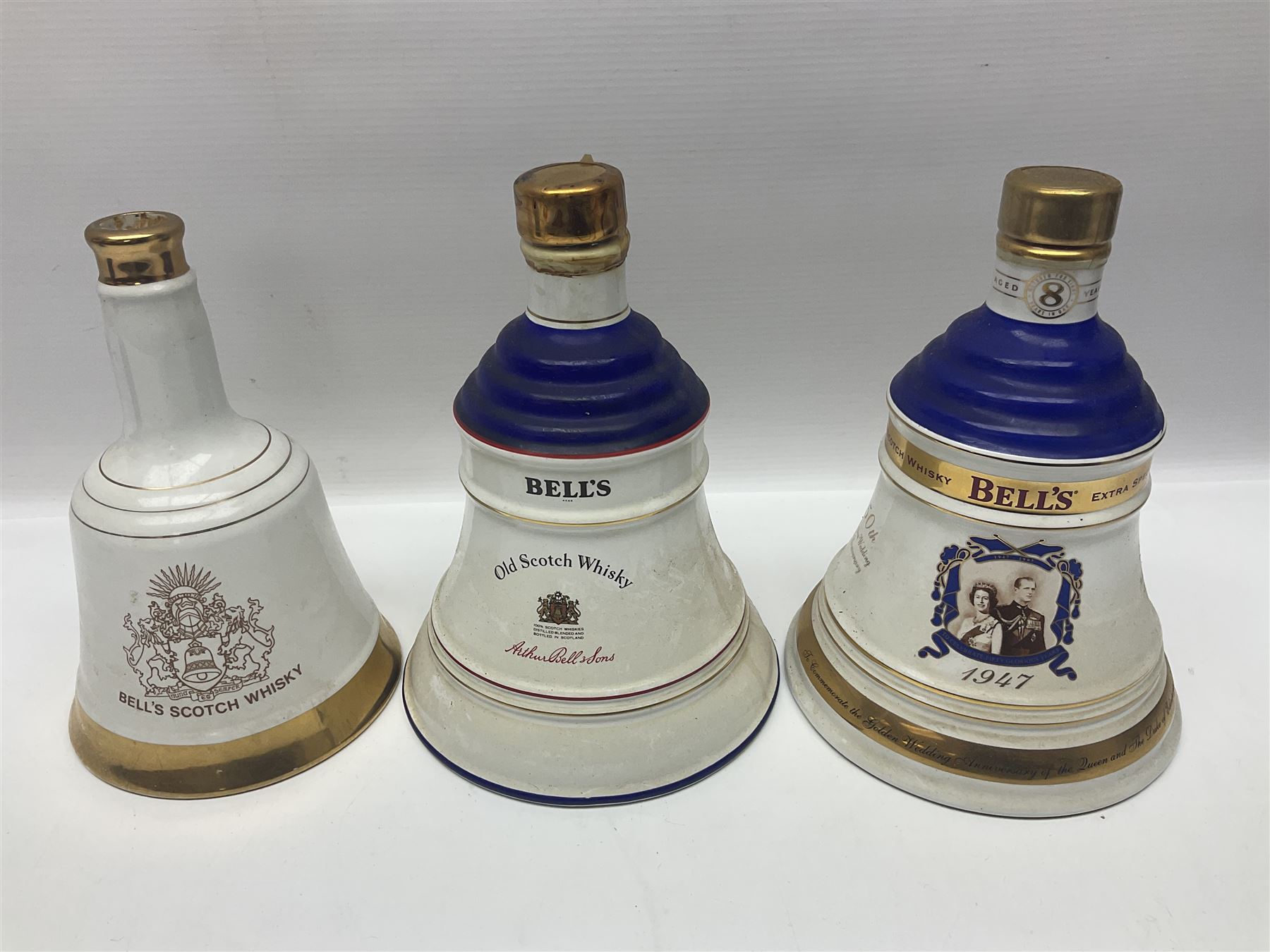 Bells, Scotch whisky, in five Wade ceramic decanters, together with Irish Mist  in novelty decanter, an empty Lambs Navy Rum decanter and similar items, of various content and proof, (11)