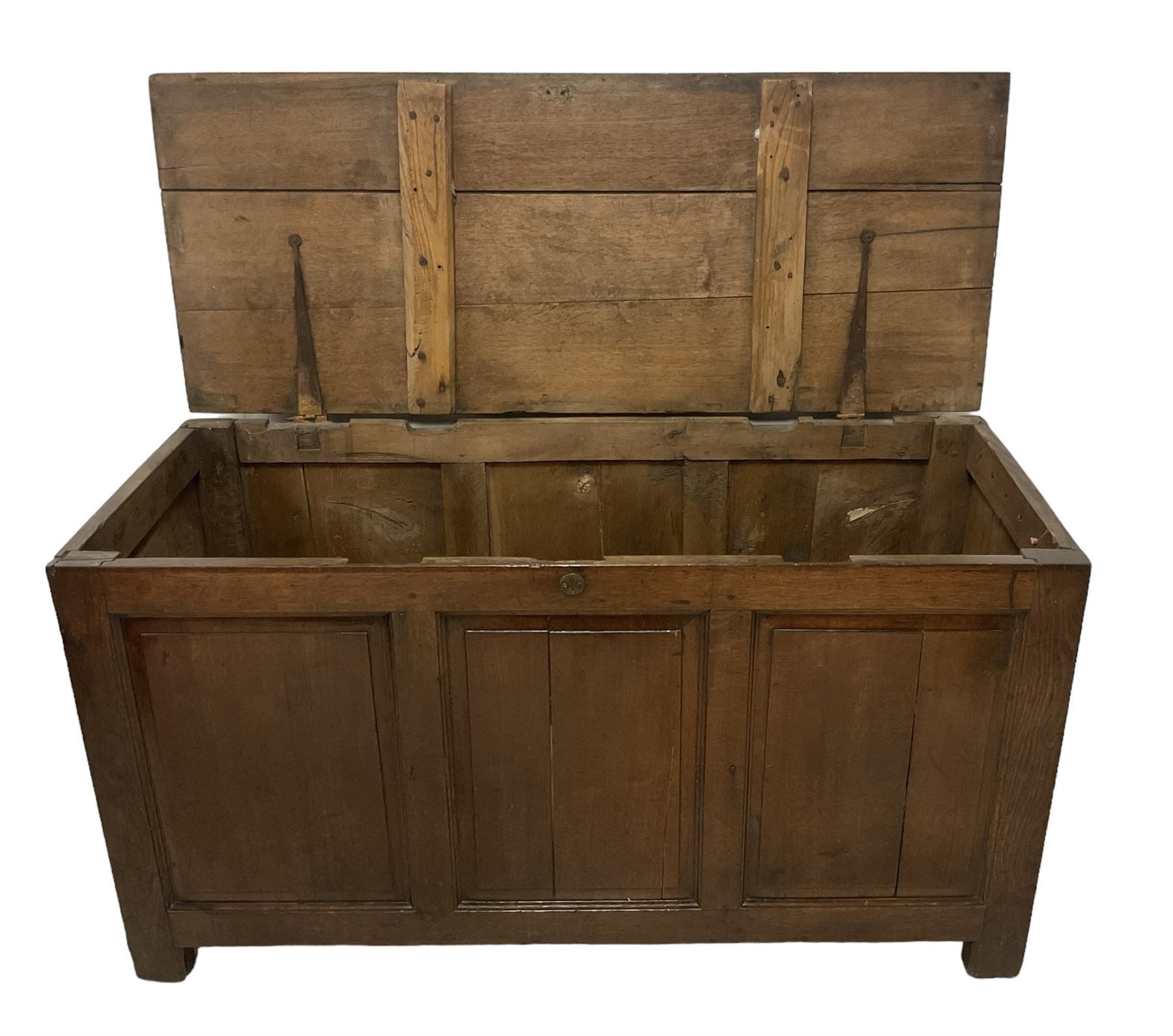 Large 18th century oak coffer or blanket box, hinged lid over triple panelled front, panelled back and sides, on stile supports 