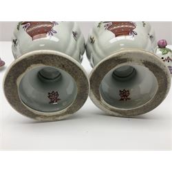 Pair of pot pourri vases and covers, decorated with floral sprigs and with rose finials to the covers, H24cm