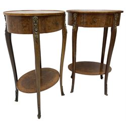 Pair of early 20th century French walnut bedside stands, oval bookmatched and cross-banded top fitted with single drawer, raised on cabriole supports united by undertier, decorated with floral gilt metal mounts