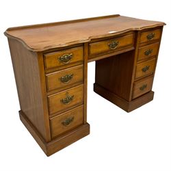 Late 19th century walnut twin pedestal desk, shaped moulded top over nine drawers, on moulded plinth base 