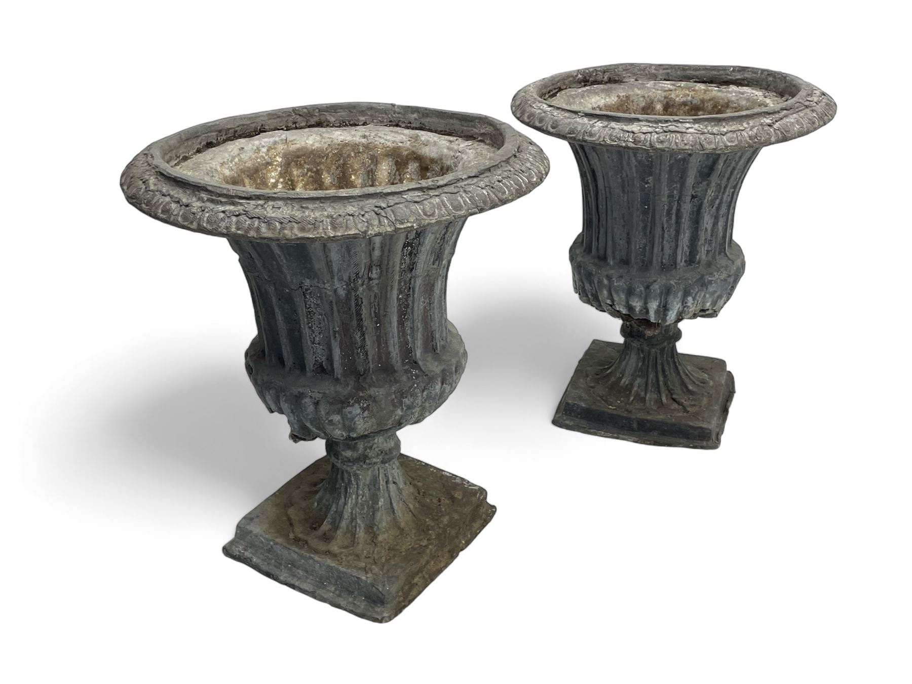 Pair of 19th century lead Campana shaped garden urns, egg and dart moulded rim, tapered fluted body over gadrooned underbelly, tapered and fluted foot on moulded square base 