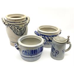 Three Westerwald stoneware twin handled pots, with scrolling decoration in cobalt blue, largest example H24cm, together with a Marzi & Remi Stein. (4). 
