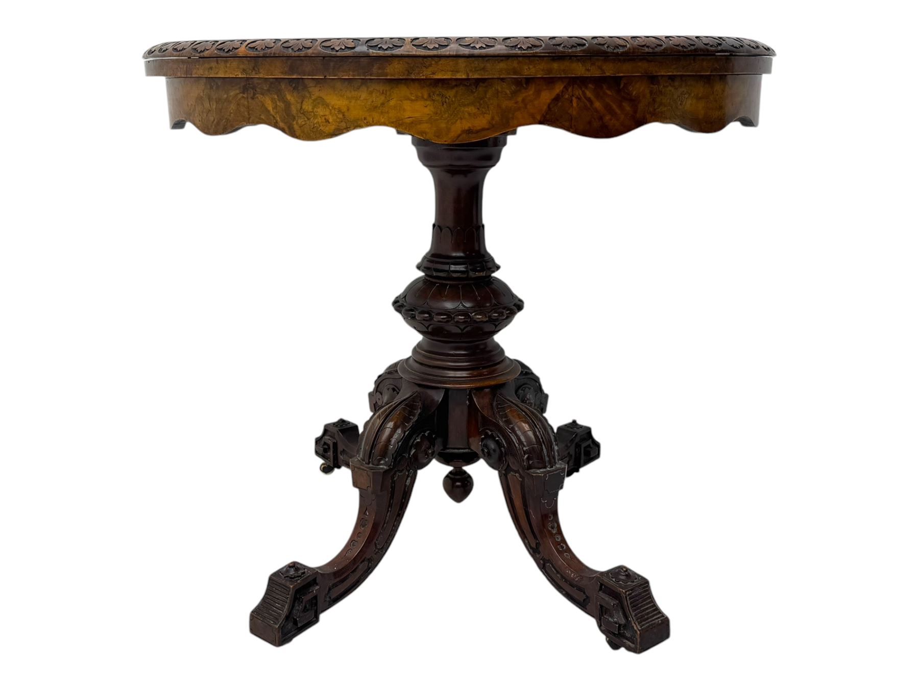 Victorian walnut demi-lune card table, circular fold-over top with foliate carved edge, revealing green baize-lined playing surface over scalloped apron, raised on a turned and carved pedestal with four splayed scroll supports with castors