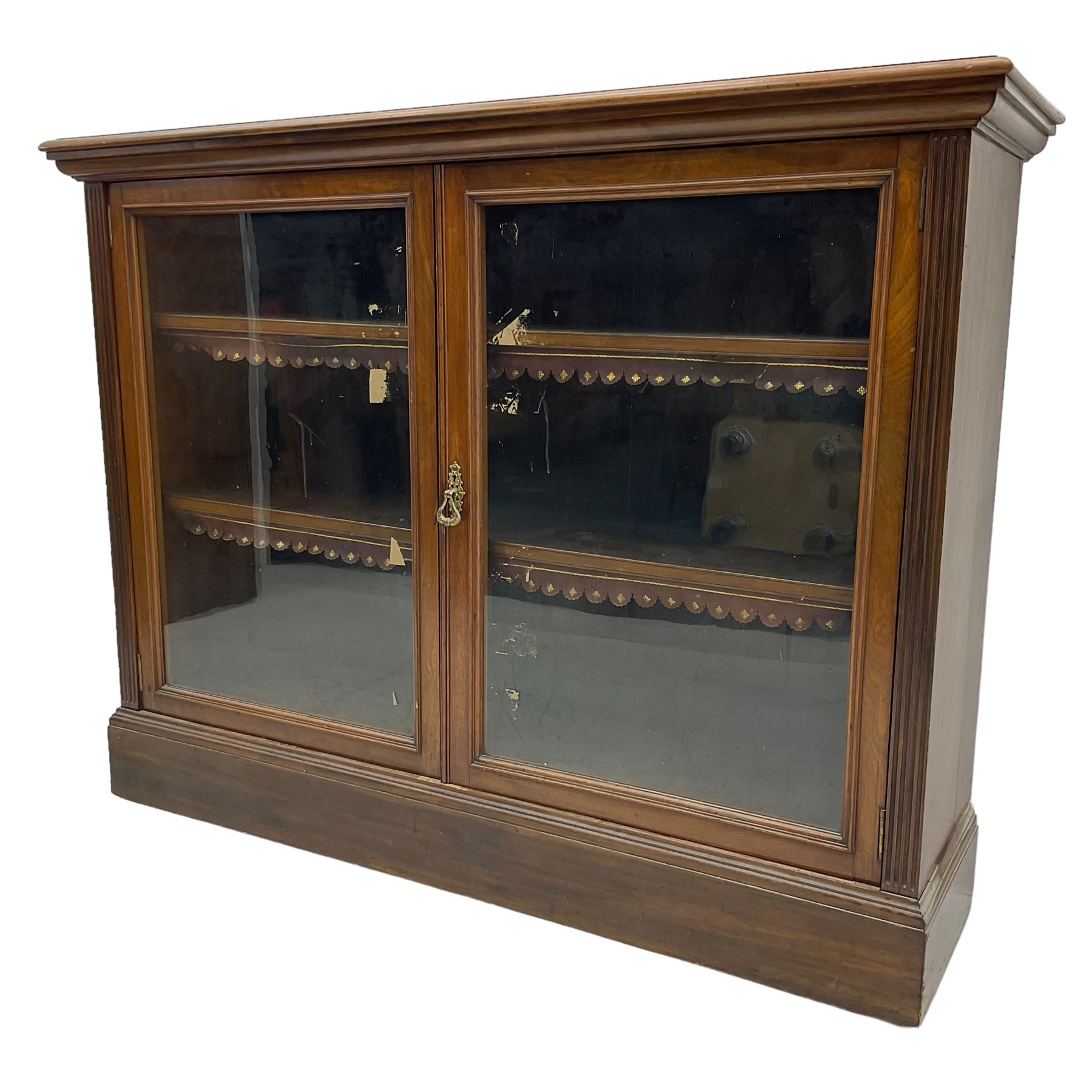 Phillips & Sons Ltd Bristol - Victorian mahogany glazed bookcase, projecting moulded cornice over two glazed doors, enclosing two shelves with scalloped edging, raised on a plinth base