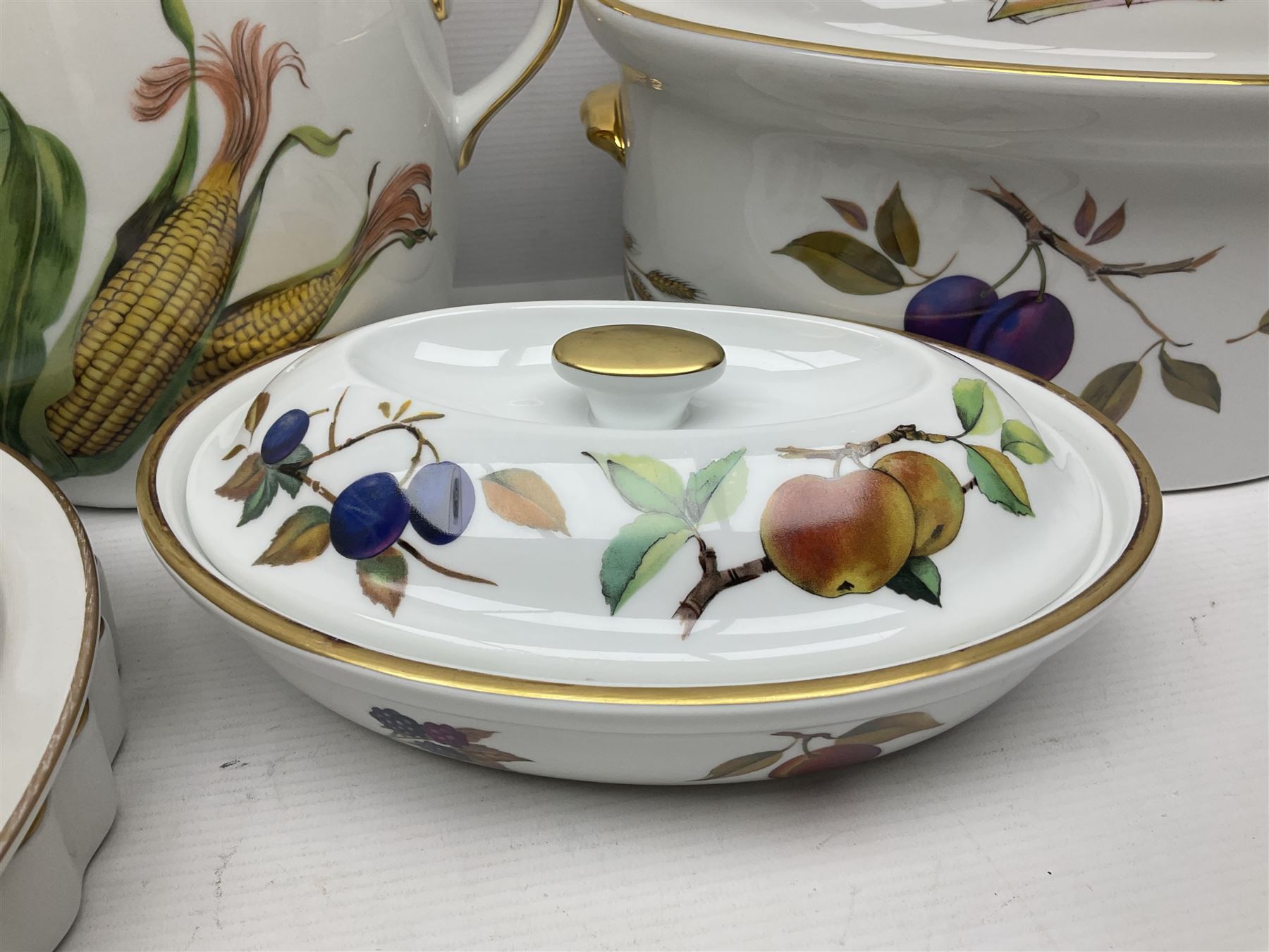 Royal Worcester Evesham pattern, including covered pot de cremes, twin handle tureen, serving dishes, flan dishes, side plates etc  