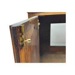 Oak drinks or media cabinet, projecting moulded cornice over two Gothic arch panelled doors on sliding tracks enclosing open storage, two drawers with brass drop handles, on bracket supports