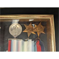 World War II medal group, including Atlantic Star and General Service medal, inscribed Thomas Crawford in glazed display frame