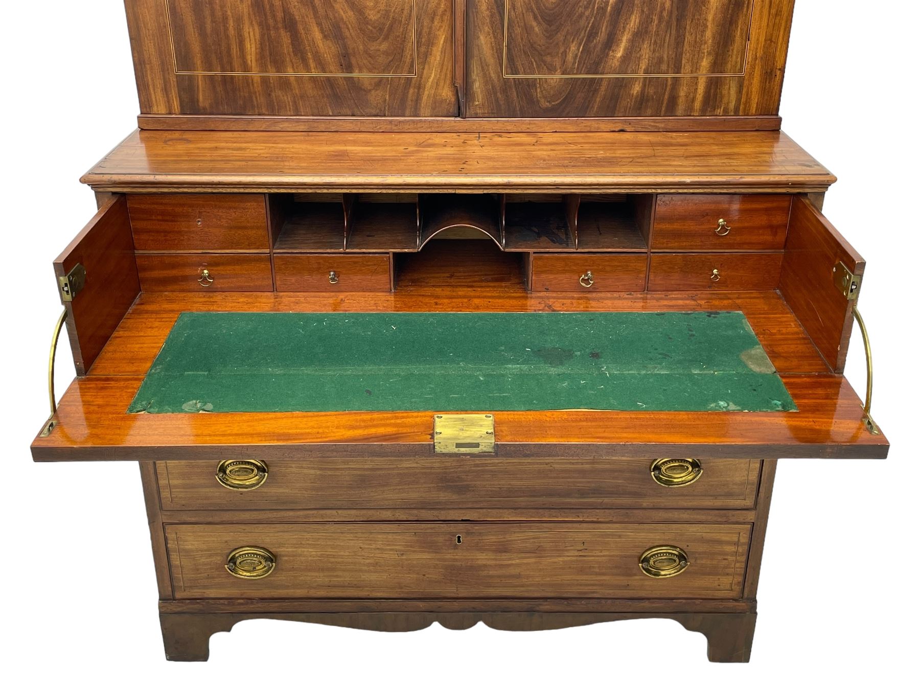 George III figured mahogany secretaire bookcase, projecting moulded dentil cornice decorated with single row of roundels, two figured mahogany doors with boxwood and ebony stringing enclosing three adjustable shelves and three drawers, moulded rectangular top over four long scratch-moulded drawers, the top secretaire drawer with fall front enclosing small drawers, pigeon holes and inset writing surface, shaped apron with bracket feet