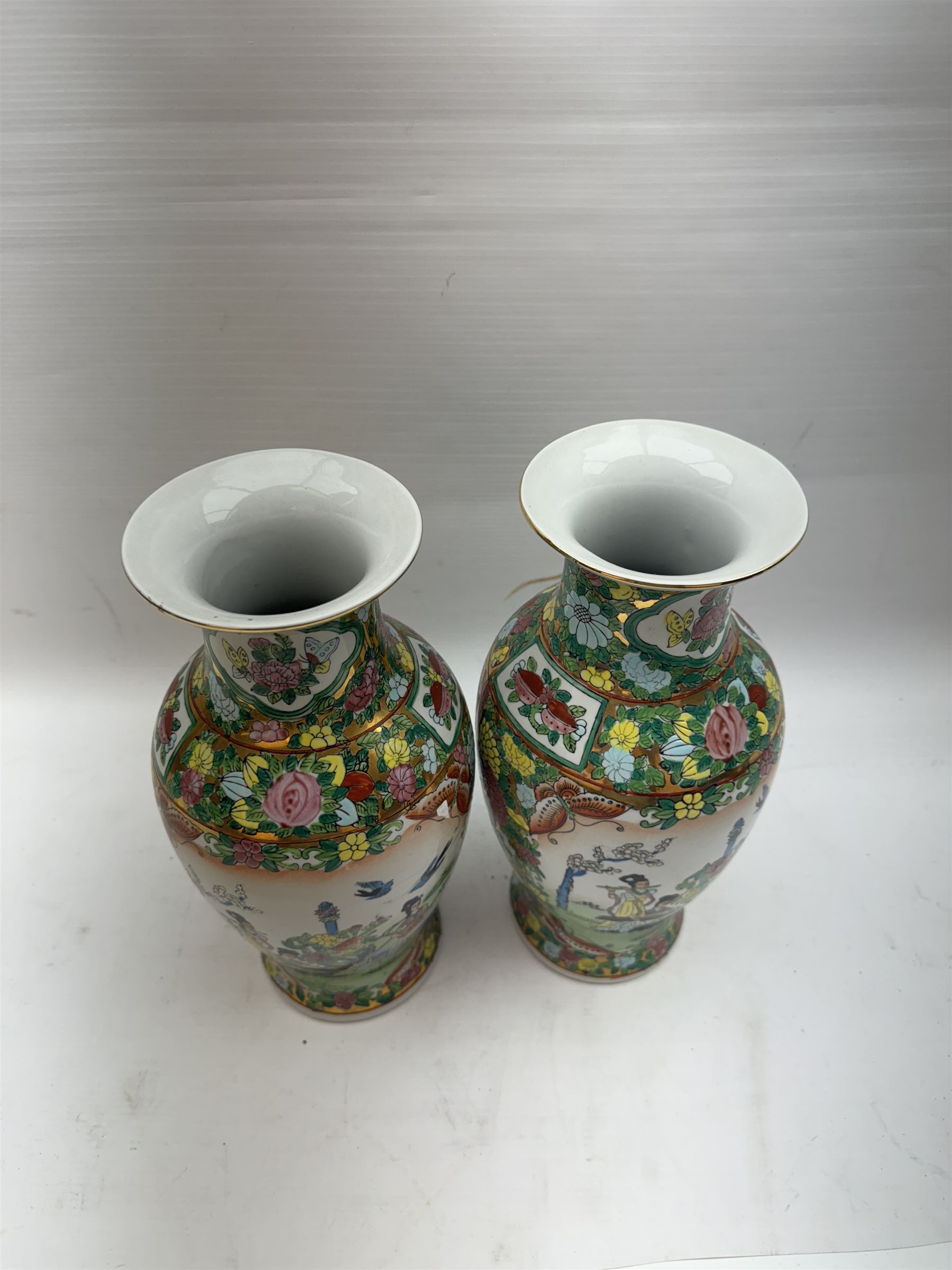 Pair of Famille Rose vases of baluster form, decorated with panels depicting musicians, H30cm