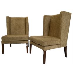 Two wing back armchairs, upholstered in oatmeal fabric