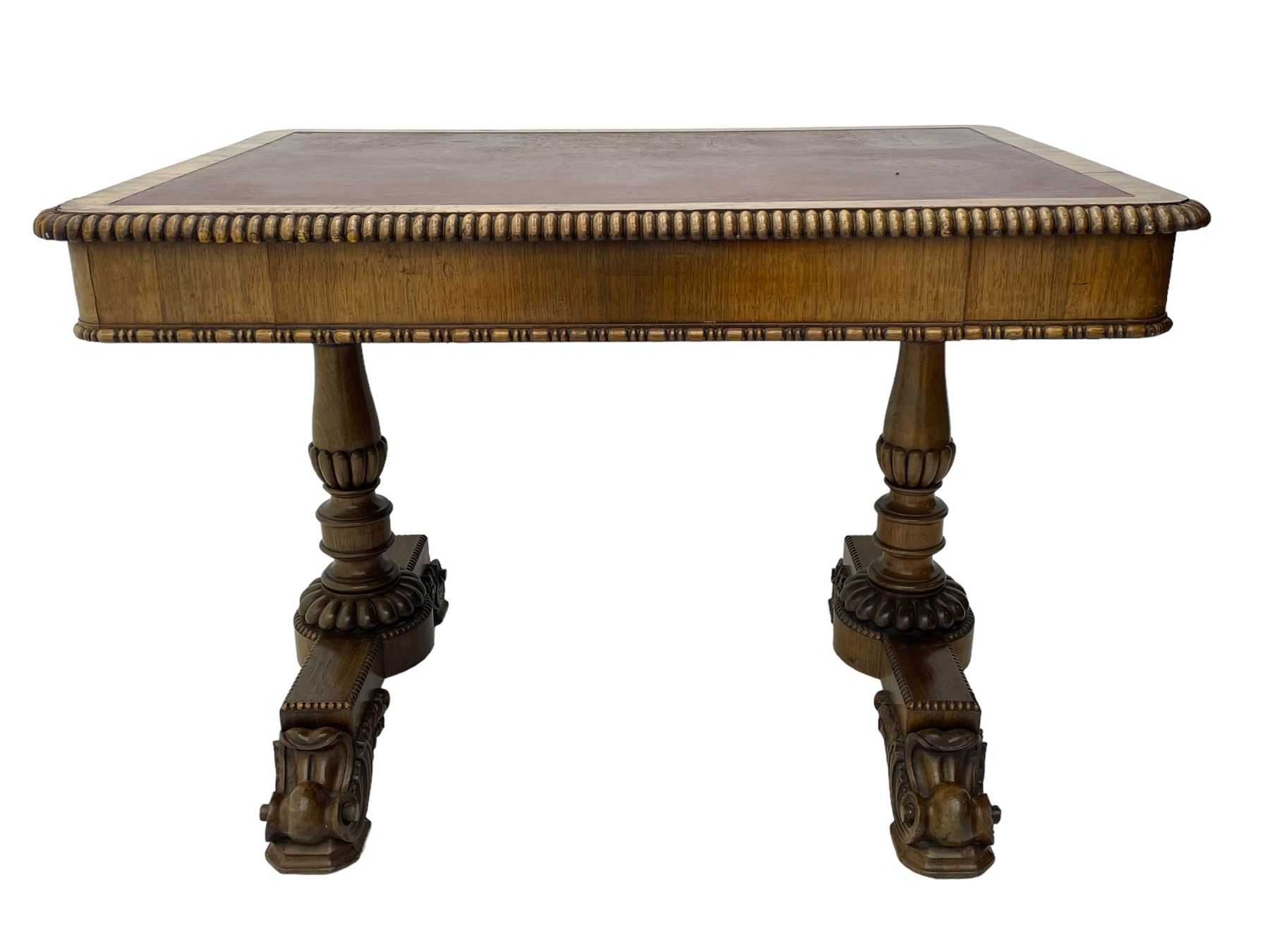 Early 19th century Regency rosewood writing table, rectangular top with inset leather writing surface and gadroon moulded edge, fitted with single frieze drawer, on twin turned pillar supports with lobe carved balusters, on platforms with beaded edge, acanthus scroll carved feet