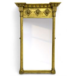 Regency giltwood and gesso pier mirror, projecting moulded cornice with globular mounts, the frieze decorated with three lion masks within lozenges, cluster column uprights with leaf decorated capitals, bevelled mirror plate