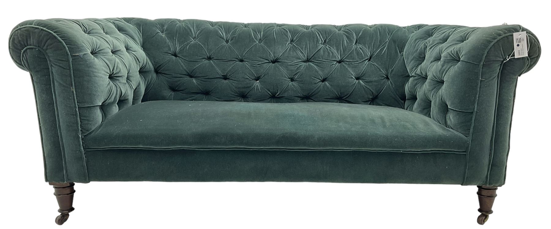 Victorian hardwood-framed Chesterfield sofa, traditional shape with low back and rolled arms, upholstered in teal buttoned fabric, on turned front feet with brass and ceramic castors 