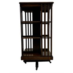 Early 20th century oak revolving bookcase, moulded square top over three tiers, with moulded vertical slats, on four spoke base with castors 