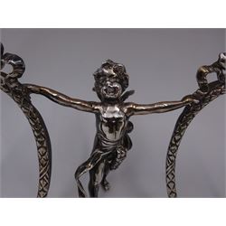 Edwardian silver double photograph frame by Berthold Herrman Muller, the oval frames each with ribbon surmount and supported by a central cherub, H8.5cm