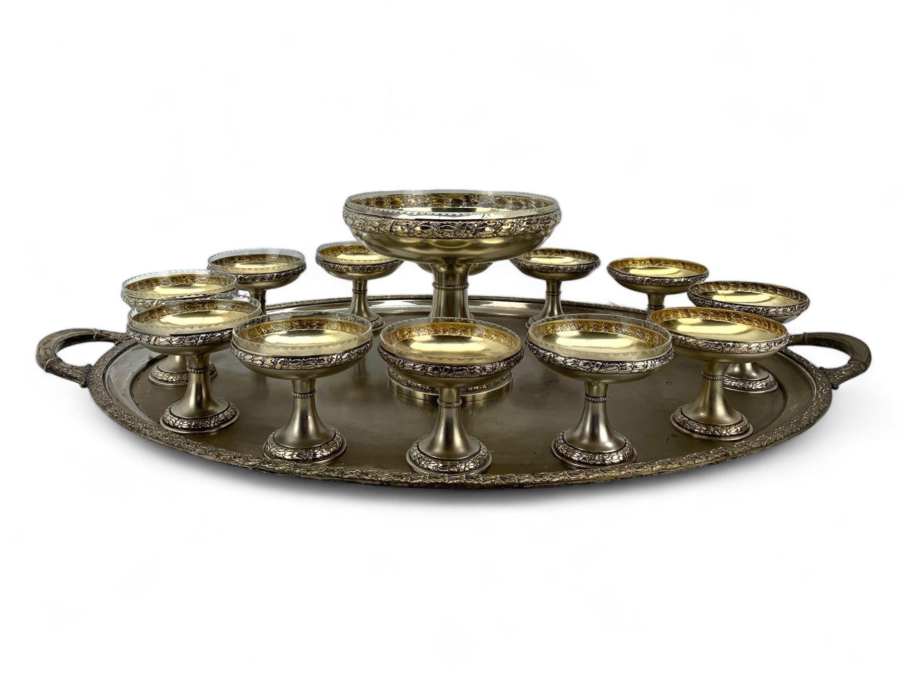 Early 20th century German silver-plated dessert service, comprising a tall comport with clear glass liner, and twelve pedestal bowls, eight with glass liners, with makers mark for Bibus Frantisek & Sohn, on a matching twin handled tray, unmarked, L82cm 