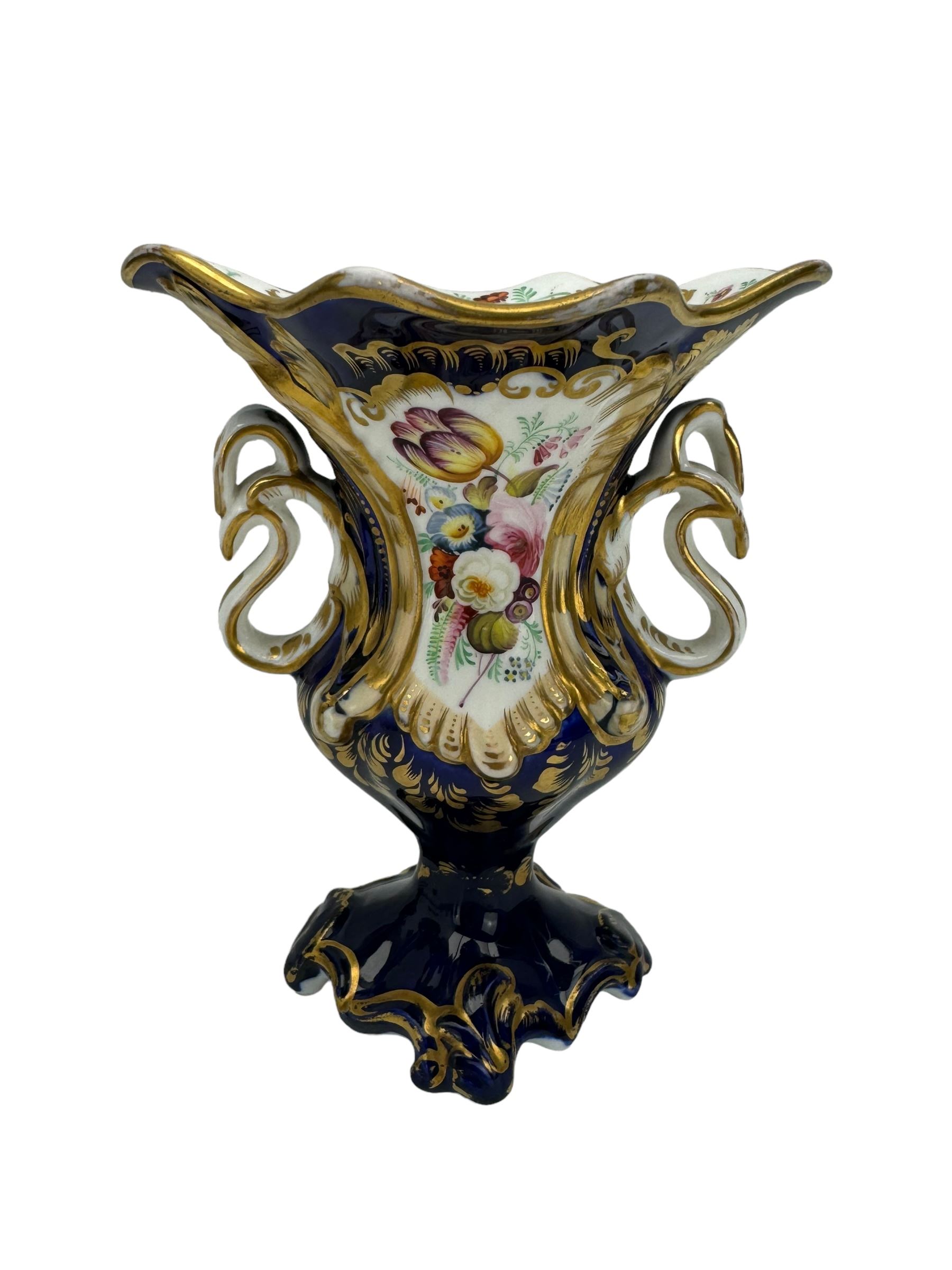 Samuel Alcock porcelain vase of footed two-handled form decorated with a panel of flowers and landscape verso, H16cm, 19th century porcelain vase with flared petal shaped rim, hand painted with a still life of shells, against a cobalt blue and gilt ground, small porcelain basket hand painted with a figure, and campana shaped urn (4)