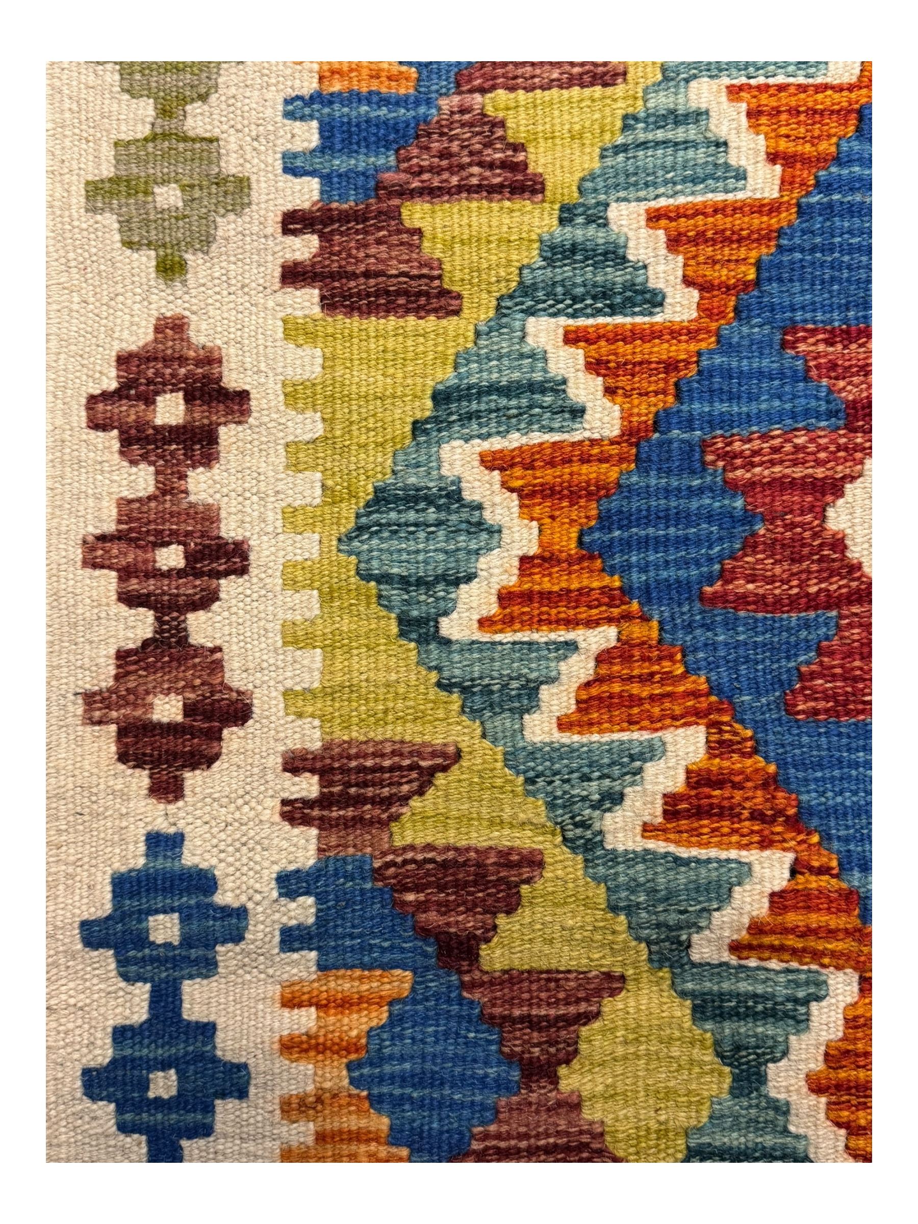 Kilim runner rug, central field decorated with four stacked geometric medallions in a multicoloured zigzag design, bordered by a series of small geometric motifs, fringed edges at both ends