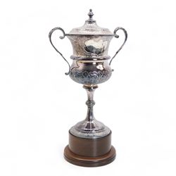 'The Racal Chesterfield Cup, Goodwood 30th July 1988' - Edwardian silver two handled cup and cover with scroll handles and leaf decoration on wooden base H52cm overall Birmingham 1908 Maker Jones & Crompton