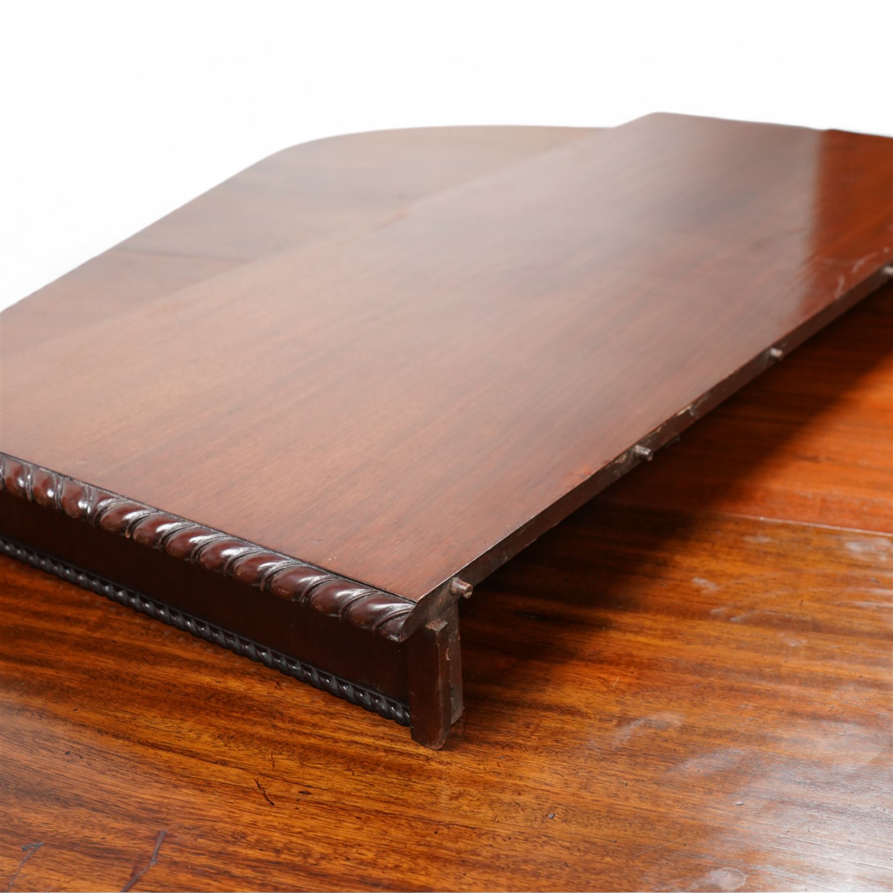 Early 20th century telescopic extending dining table, gardroon carved rectangular top with rounded ends, scrolled acanthus leaf carved cabriole supports with ball and claw feet, on brass castors, with two additional leaves  