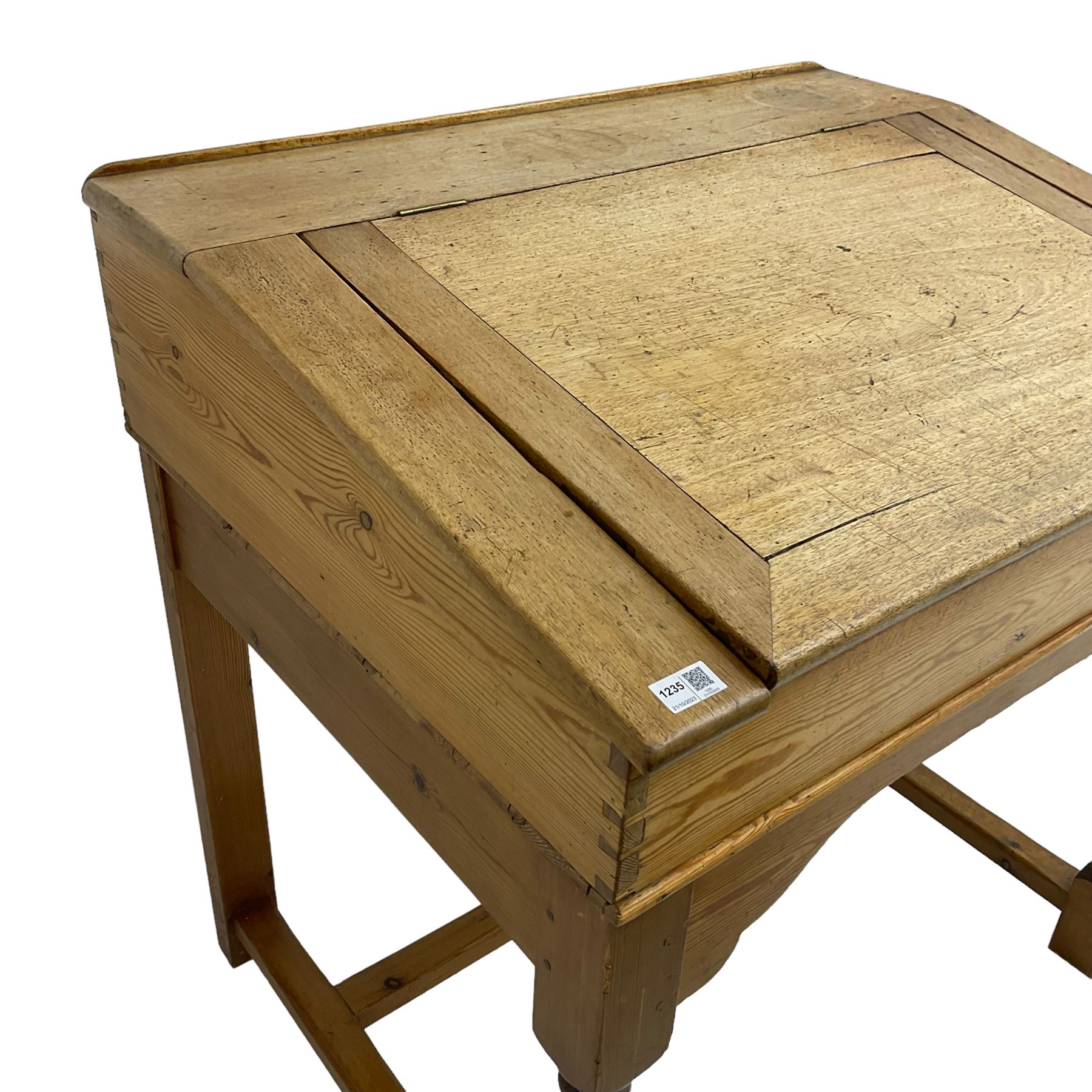 Early 20th century pitch pine clerk’s desk, stripped mahogany sloped hinged top, raised on turned supports