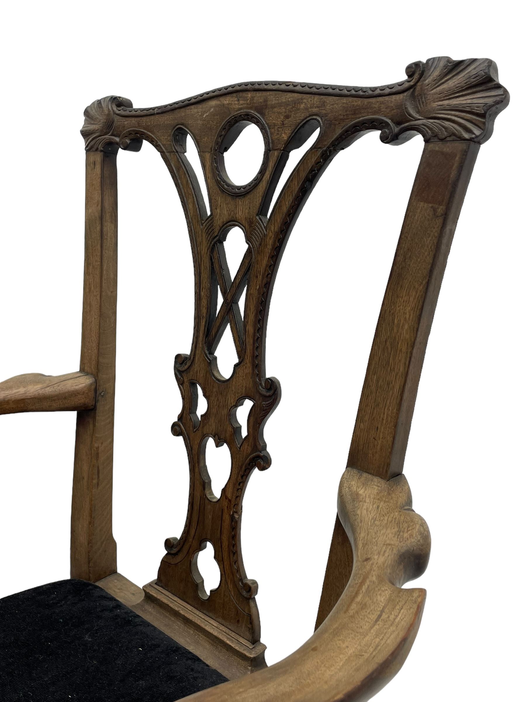 Unusual 18th century mahogany elbow chair, the shaped cresting rail with projecting shell carved ears, pierced and scroll carved splat over drop-in upholstered seat, shaped arms with ball and claw carved terminals, the seat rails carved with shell cartouches, on foliate carved cabriole supports with ball and claw feet 