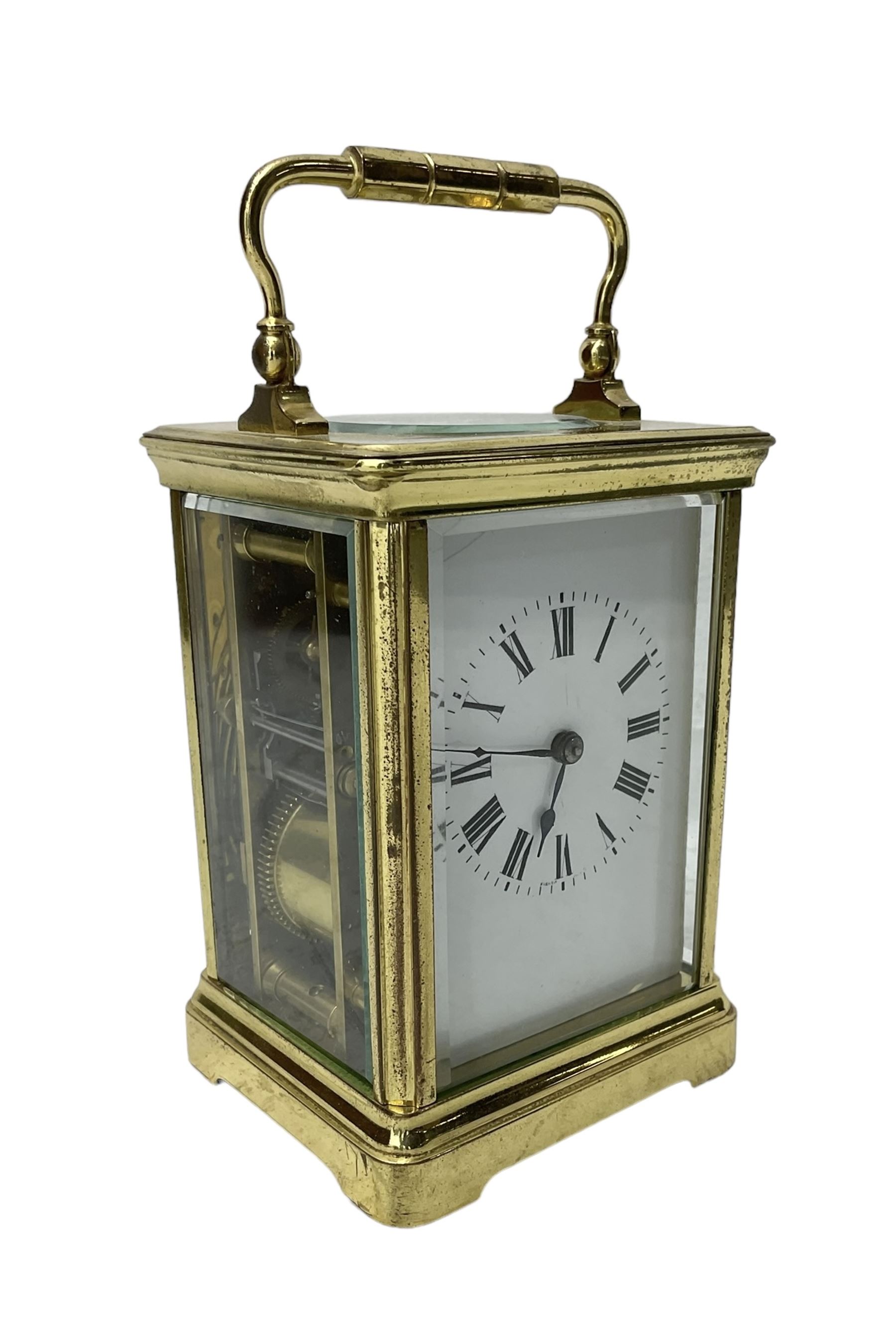 20th century -  8-day striking carriage clock in a corniche case, with an enamel dial , Roman numerals, minute track and steel spade hands, twin train going barrel movement with a lever platform escapement and rack striking, sounding the hours and half hours on a coiled gong.  With key.