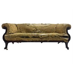 19th century mahogany settee, rolled S-scrolled arms carved with lion masks and acanthus leaf scrolls, the lower moulded rail carved with scrolling design, raised on carved paw feet with recessed brass and ceramic castors 