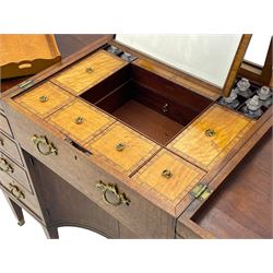 Late 19th century mahogany and satinwood dressing chest, the raised middle section hinges to reveal an interior fitted with lidded compartments, removable tray, single drawer and glass scent bottles, lift-up bevelled mirror with adjustable hinged mechanism, fitted with a further eight cock-beaded graduating drawers and curved kneehole with double cupboard, square tapering supports on brass cups and castors, inlaid throughout with checkered stringing, ornate Rococo cast gilt metal handles