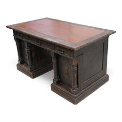 Late Victorian oak twin pedestal desk, rectangular moulded top with brown leather inset, three drawers fitted with Aesthetic Movement angular handles, each pedestal enclosed by door with turned columns, on moulded plinth base 