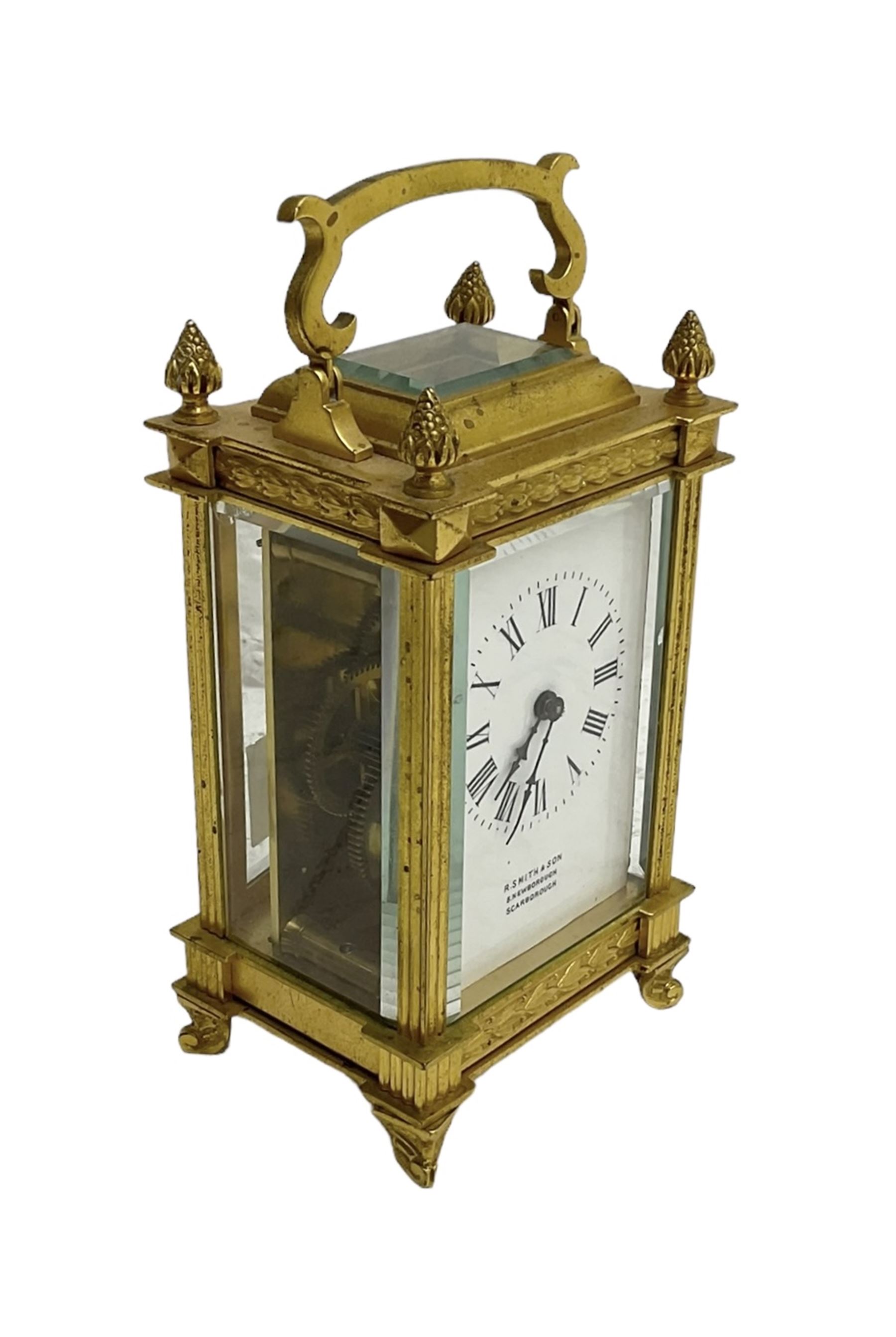 Early 20th century French carriage clock - 8-day timepiece movement in a decorative case with bevelled glass panels, white enamel dial with Roman numerals, minute markers and steel hands, retailed by Smith and Son, Scarborough, original lever platform escapement, with key.