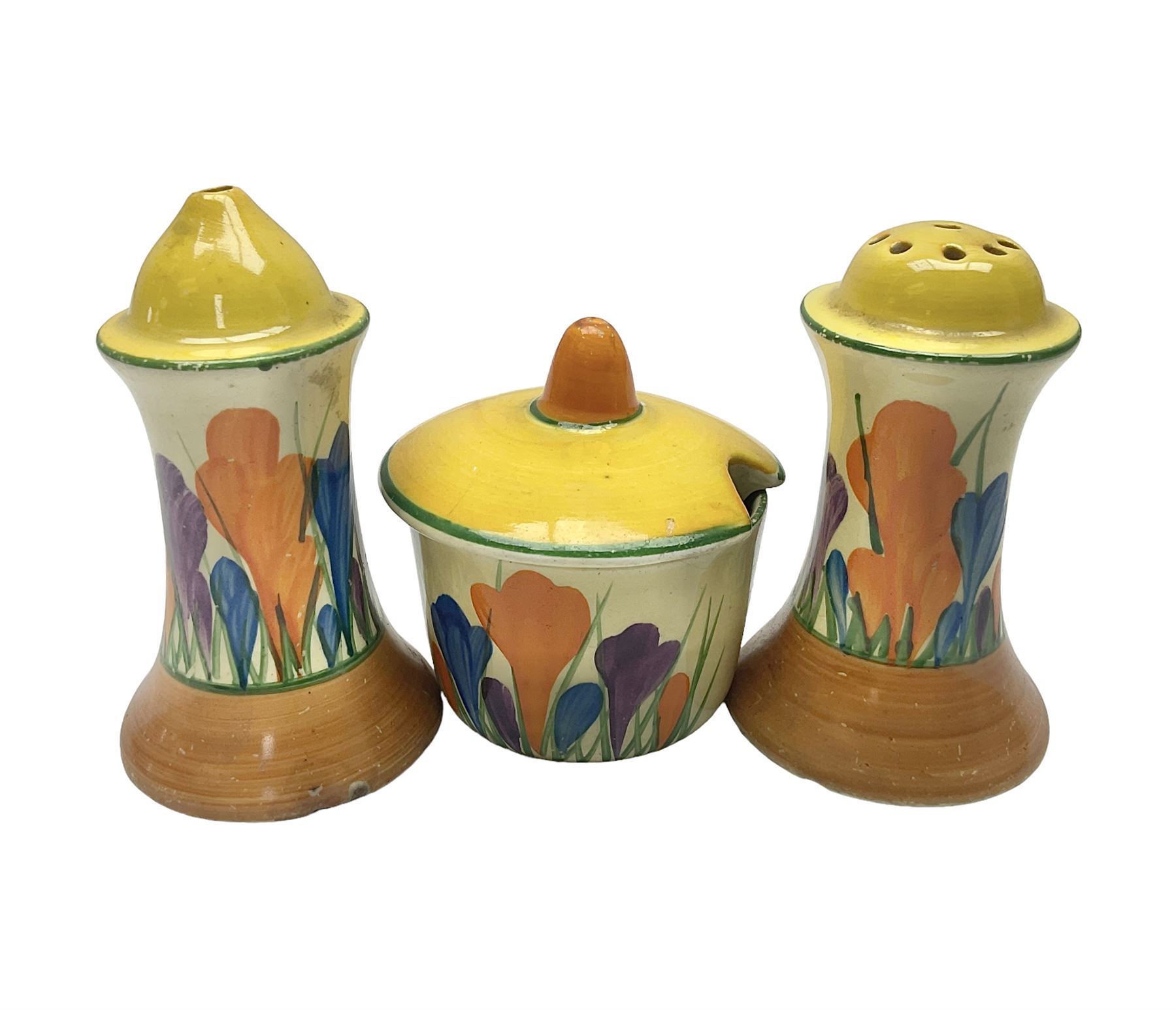 Clarice Cliff Bizarre for Newport Pottery, Muffineer cruet set in Crocus pattern, comprising mustard pot, salt shaker and pepper shaker, with printed marks beneath  