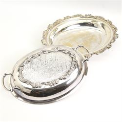 Continental silver-plated part dinner service comprising two graduated entree dishes & oval platters and salver, all having scroll cast borders and foliate engraved design, oval tray max L65cm 