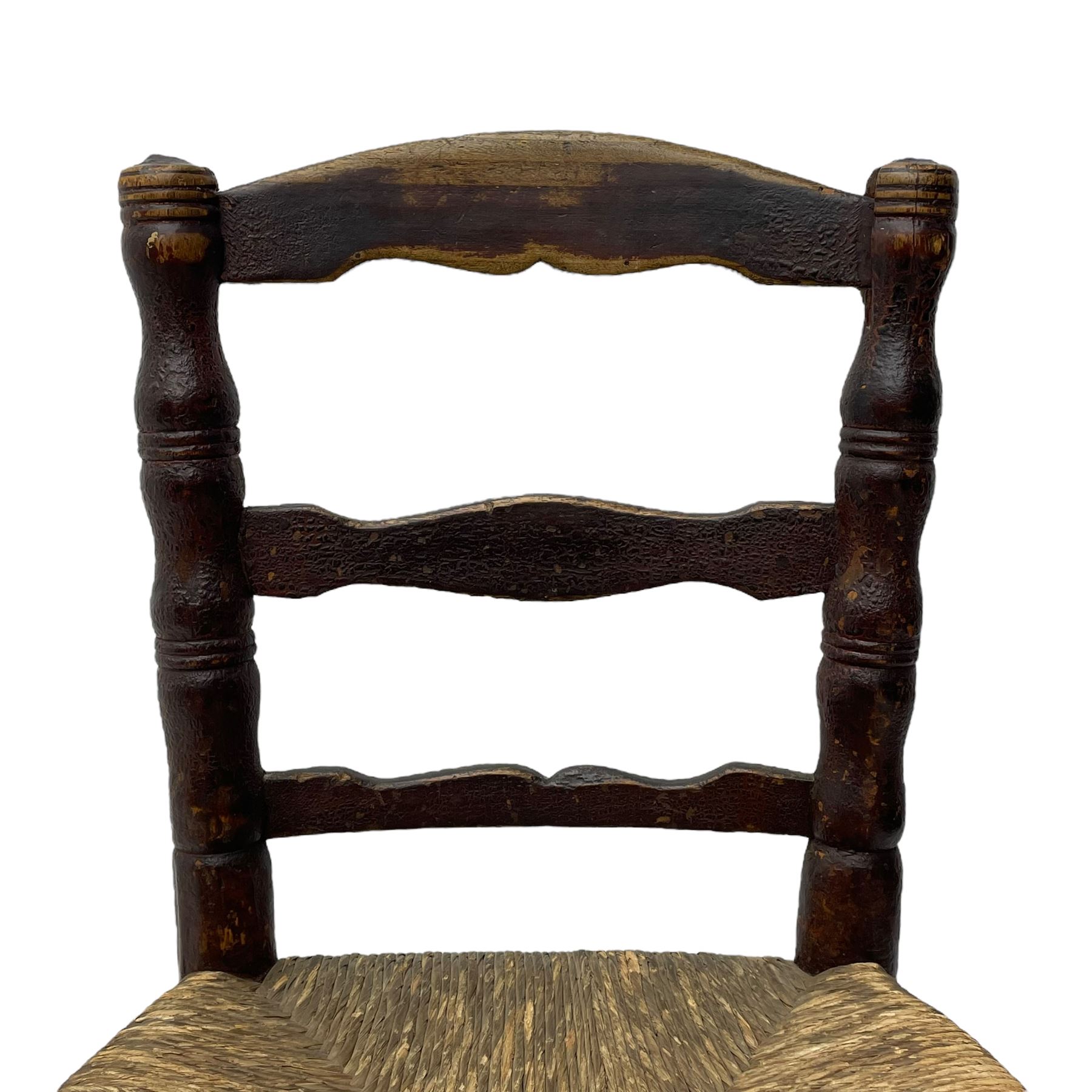 19th century painted elm primitive fire side chair, ladder back over rush seat, on turned supports united by turned stretchers 