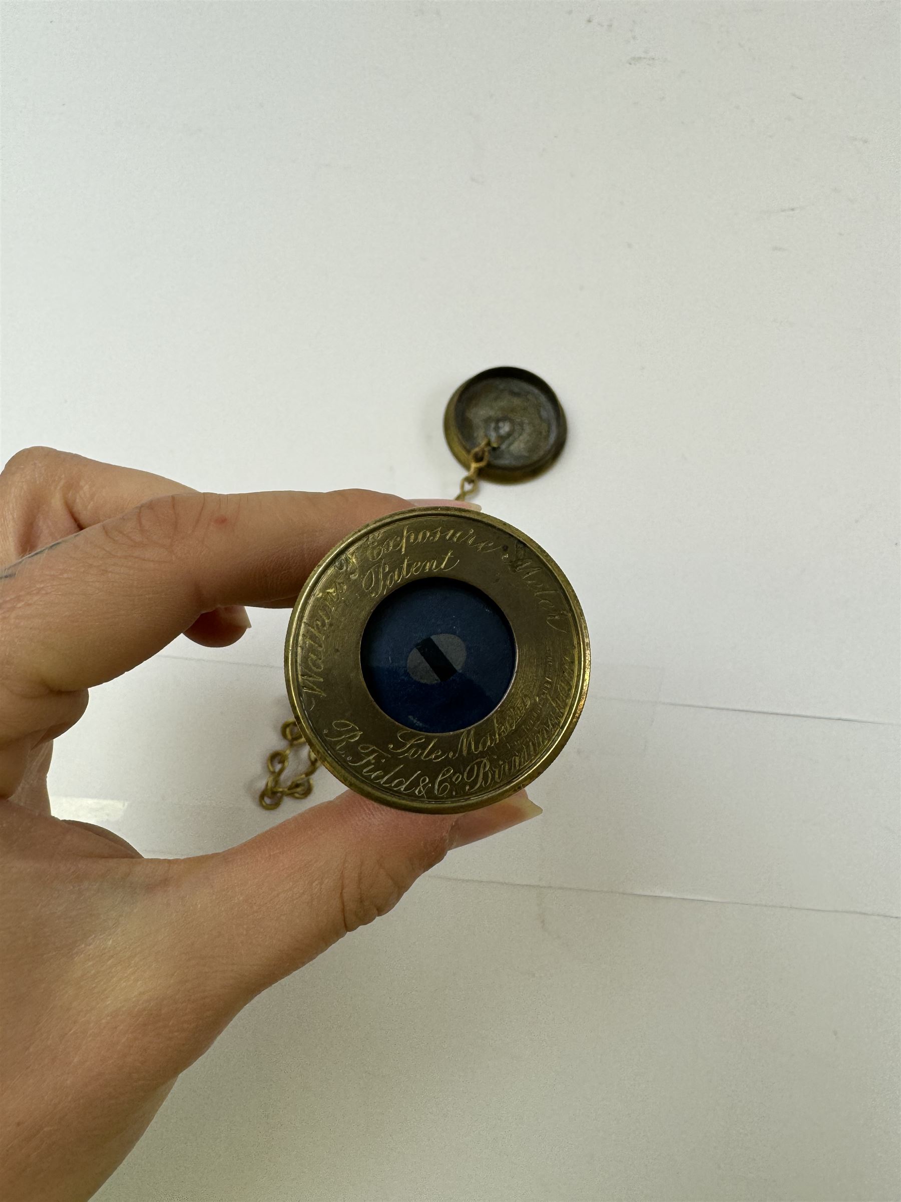 Late 19th century Watkins Exposure Meter, in cylindrical brass case, inscribed Sole Makers R. Field & Co, Birmingham, together with a 19th century brass plate camera lens