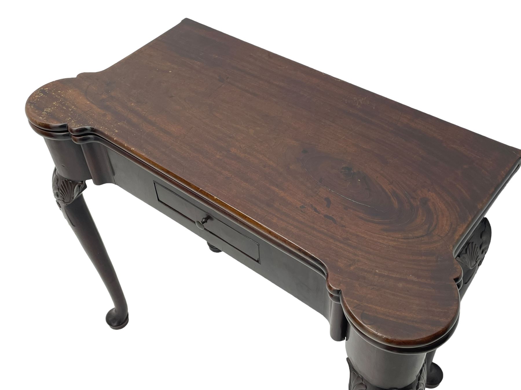 Late 18th century Irish mahogany tea table, rectangular form with projecting stepped rounded corners, fold-over action top over single frieze drawer within cock-beaded surround, on shell and bellflower carved cabriole supports, single gate-leg action base 