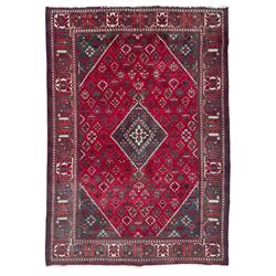 Persian Meymeh red ground rug, stepped lozenge medallion and spandrels, decorated all over with tree of life motifs, the main border decorated with repeating stylised plant motifs within geometric guard stripes 