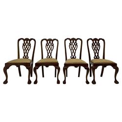 Set of twelve Chippendale design mahogany dining chairs, shaped cresting rail carved with foliage and C-scrolls, pierced interlaced splat with curled leaf decoration, upholstered drop-in seat, moulded seat rails, on scrolled acanthus carved cabriole supports with ball and claw feet 