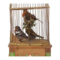 Late 19th century coin operated trio of singing birds in cage automaton, probably by J Phalibois, French, the three taxidermy birds with moving heads, beaks and tail feathers synchronized to the birdsong, under a gilt brass cage with one penny coin entry shoot, The gilt canted rectangular base with barbola decoration, H58cm