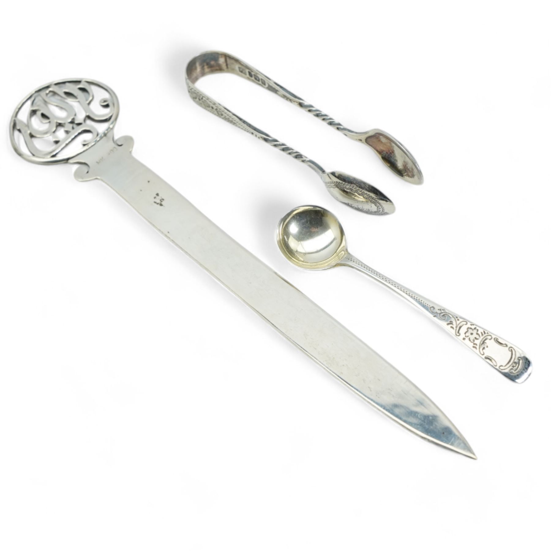 Small silver comport with inscription D10cm, 800 standard silver paper knife with pierced finial, silver matchbox holder, silver serviette ring, sugar tongs and salt spoon 