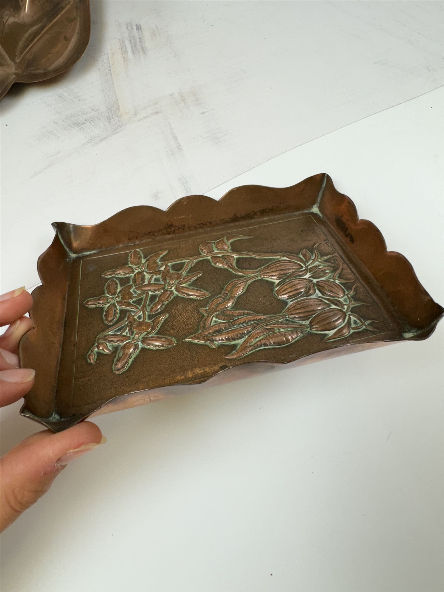 Keswick School of Industrial Arts, flared vase of cylindrical form, together with an Arts and Crafts plated copper, an embossed tray, copper dishes and charger 