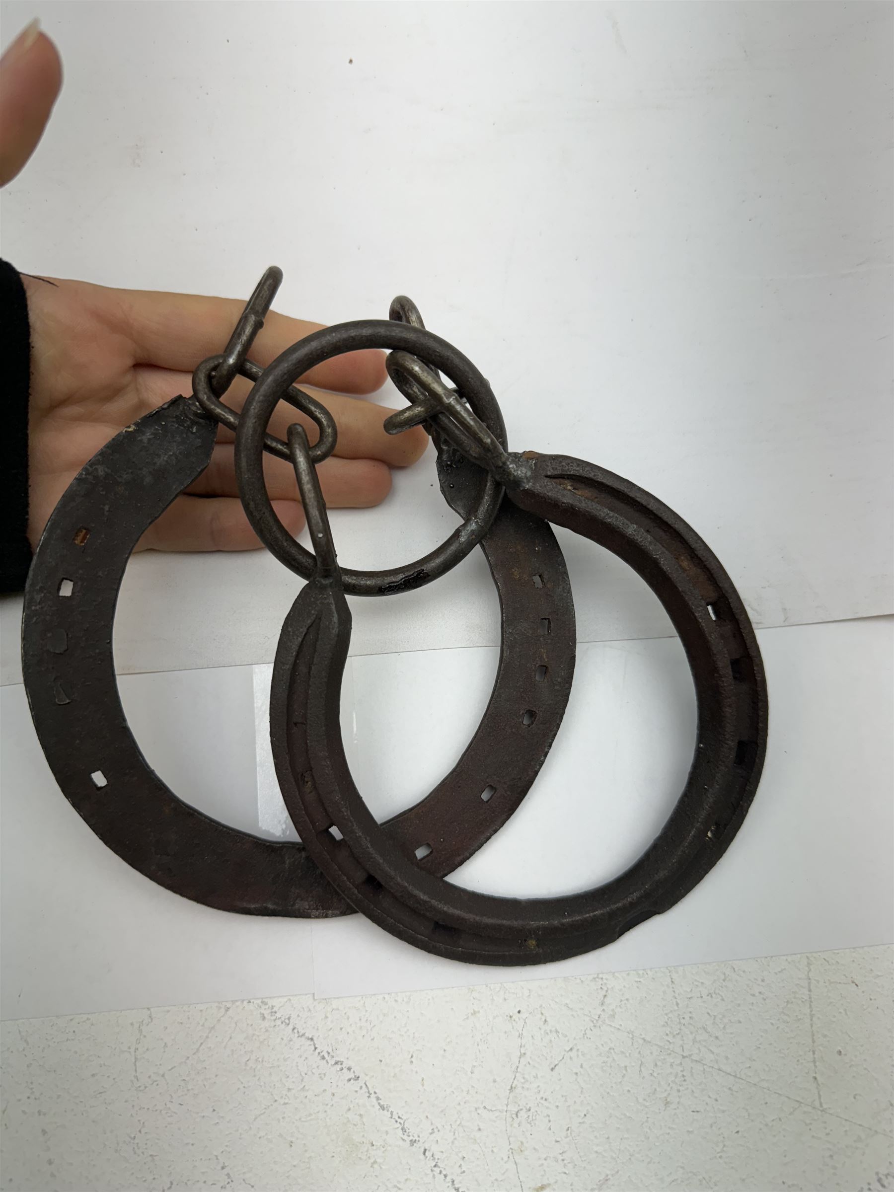 Hiatt handcuff and leg chains, together with leather collar with brass cow bells and similar items 