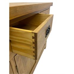 Contemporary light oak sideboard, fitted with three drawers over three panelled cupboards enclosing shelving, on square supports