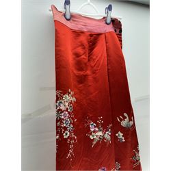 Early 20th century Chinese Han silk skirt, embroidered with flowers and butterflies, on a red ground, purchased from Liberty, London