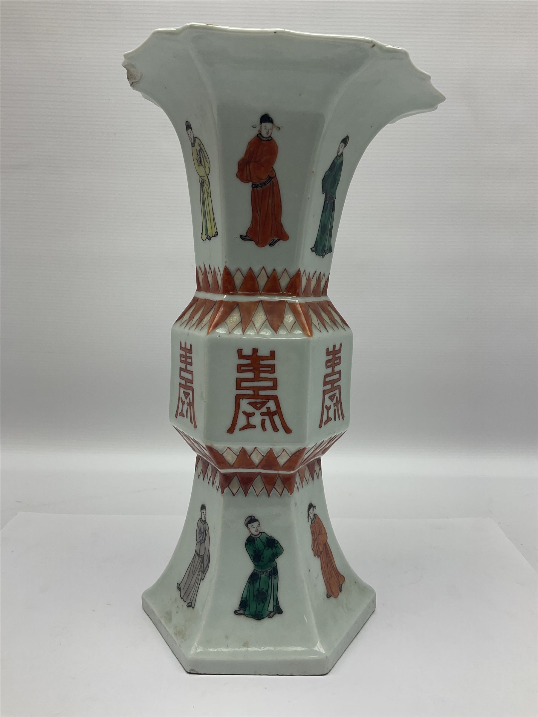 Chinese Kangxi gu vase, of hexagonal form with fluted rim, decorated in polychrome enamels with a male figure to each panel and red character marks to centre, with painted red leaf mark beneath, H32.5cm